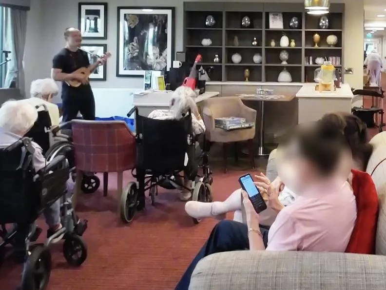 Group music engagement session with elderly residents at a care home — ukulele-based Active Musical Engagement by The Ministry of Happier
